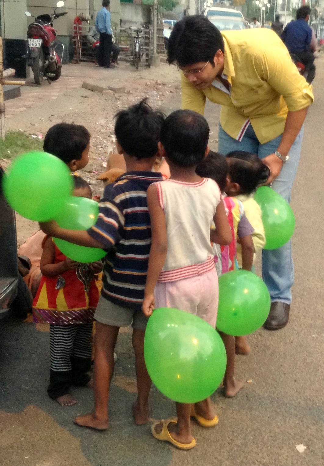 Vipul Gupta, Director Finance, distributing chocolates to children